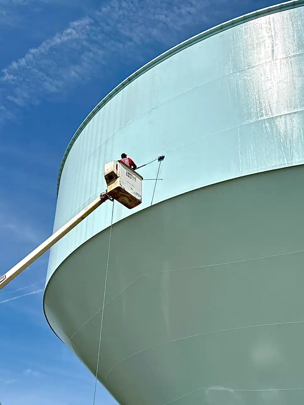 Exterior cleaning Worker on an elevator cleaning commercial property exterior.